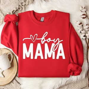 May include: Red sweatshirt with white text that says "boy mama" with a small heart above the word "boy".