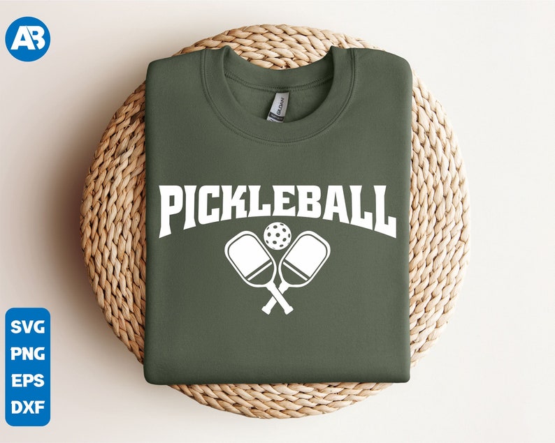 May include: A green sweatshirt with the text "Pickleball" in white letters and a white graphic of two pickleball paddles and a ball.