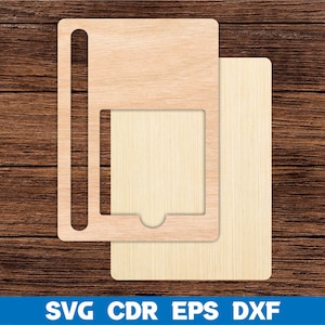 May include: A wooden phone stand with a slot for a phone and a cutout for a charging cable. The stand is made of two pieces of wood, one with a grain pattern and the other with a smooth surface.