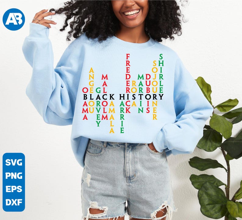 May include: A light blue sweatshirt with a word search design that reads "Black History" in black letters. The words are arranged in a grid pattern with red, green, and yellow letters.