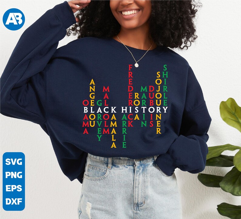 May include: A navy blue sweatshirt with a word puzzle design featuring the words "Black History" in red, green, and yellow letters. The words are arranged in a grid pattern, creating a visual representation of the phrase.