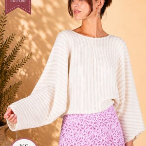 May include: A PDF sewing pattern for a cream-coloured, long-sleeved, ribbed knit sweater with a wide, loose fit and a round neckline. The pattern is available in sizes ranging from XS to 4XL, as indicated by the text on the image.
