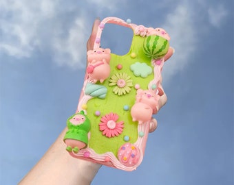 May include: A green and pink phone case with a watermelon, pig, and flower design. The case is made of silicone and has a raised design.