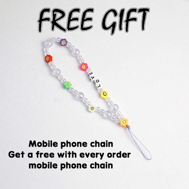May include: A white beaded phone chain with colorful flower and smiley face charms. The chain has a purple string attached to it. The text "FREE GIFT" is at the top of the image. The text "LOVE" is on the chain. The text "Mobile phone chain Get a free with every order mobile phone chain" is at the bottom of the image.