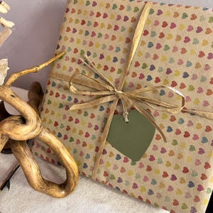 Gift wrapped in recycled heart print paper with natural ribbon and green heart tag