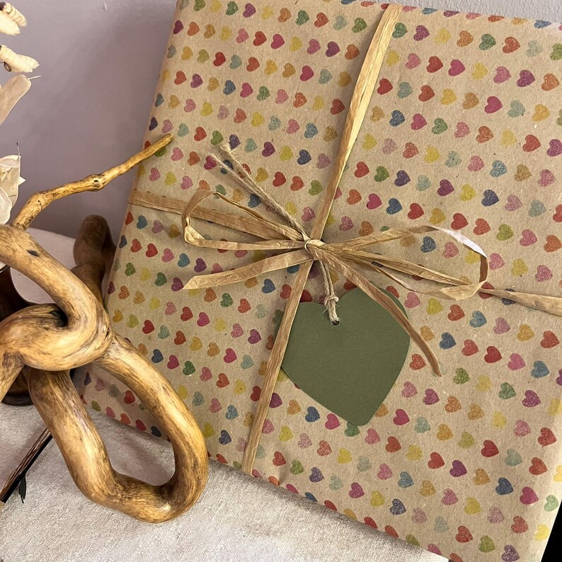 Gift wrapped in recycled heart print paper with natural ribbon and green heart tag