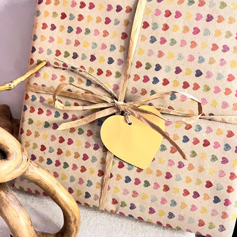 Gift wrapped in recycled heart print paper with natural ribbon and yellow heart tag