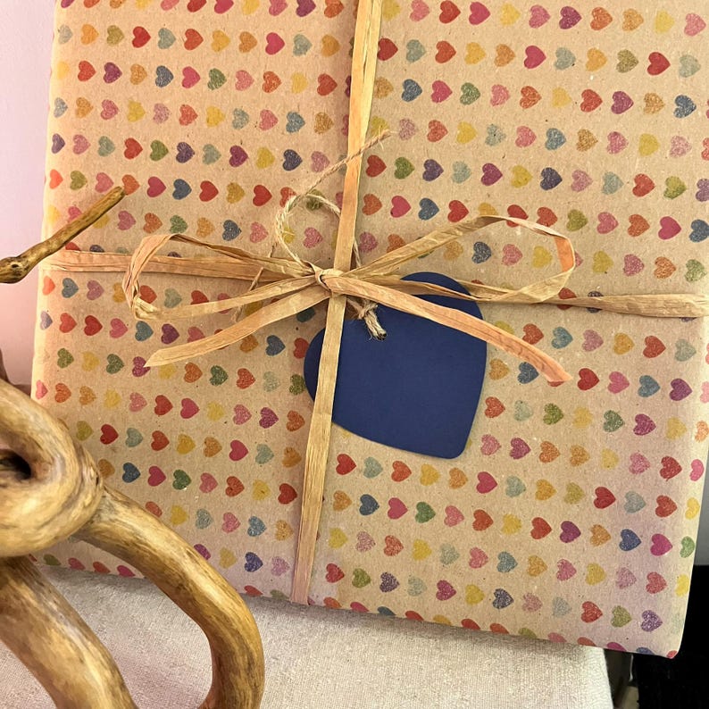 Gift wrapped in recycled heart print paper with natural ribbon and blue heart tag