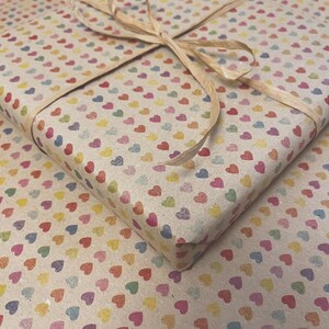 Recycled kraft wrapping paper with soft understated heart pattern, printed with vegetable inks