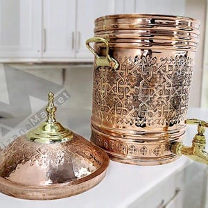 a beautifully handicrafted copper water dispenser with intricate engravings and traditional motifs, reflecting exquisite craftsmanship.