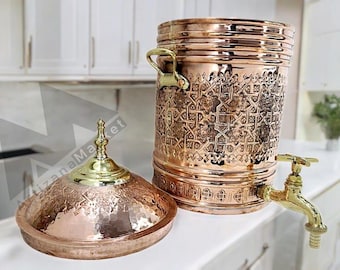 a beautifully handicrafted copper water dispenser with intricate engravings and traditional motifs, reflecting exquisite craftsmanship.