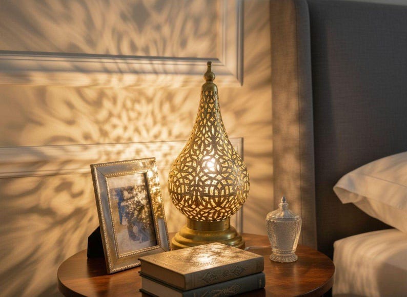 Ornate engraved brass lamp with soft ambient lighting for cozy interior design.