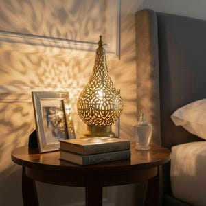 Antique brass table lamp handcrafted in Morocco, adds a warm glow to any room.