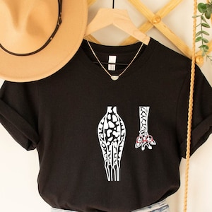 May include: Black t-shirt featuring a white graphic of a giraffe's legs and head wearing glasses. The giraffe is wearing glasses.