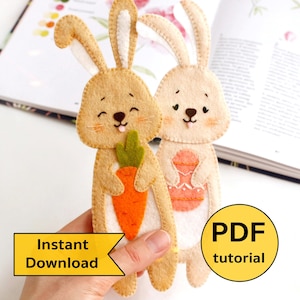 May include: Two felt bunny bookmarks, one holding a carrot and the other holding an Easter egg. The bookmarks are brown and beige with white accents. The text "Instant Download" and "PDF tutorial" is visible in the image.