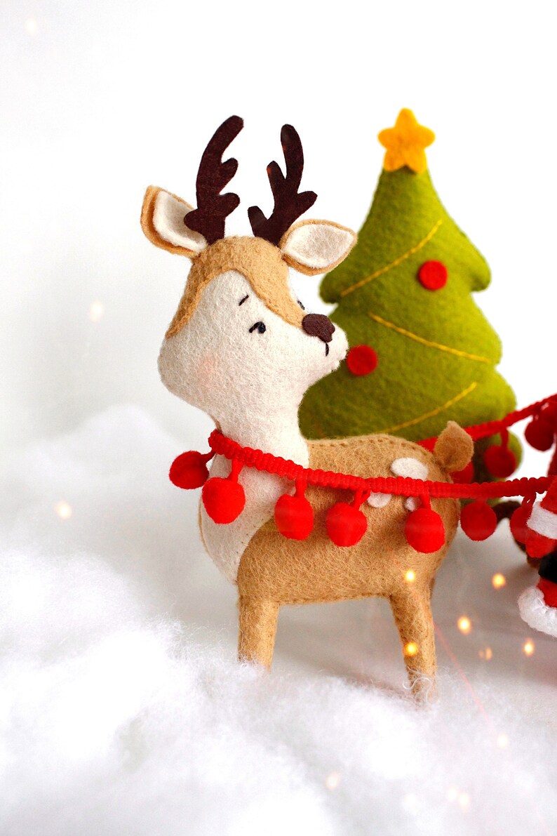 Felt reindeer Rudolph near Christmas tree