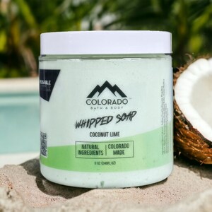 May include: A white jar of whipped soap with a green lid. The jar is labelled "Colorado Bath & Body Whipped Soap Coconut Lime Natural Ingredients Colorado Made 8 oz (240 fl oz)".