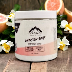 May include: A white jar of whipped soap with a pink label that says "COLORADO BATH & BODY WHIPPED SOAP GRAPEFRUIT NEROLI NATURAL INGREDIENTS COLORADO MADE 8 OZ (240FL OZ)".