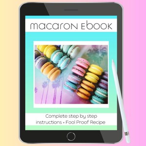 May include: A digital tablet displaying a colorful image of macarons with the text "macarons Ebook" and "Complete step by step instructions + Fool Proof Recipe".