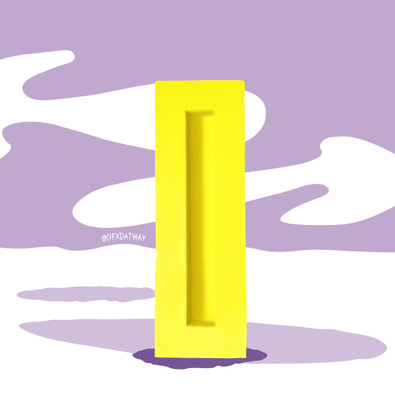 May include: A bright yellow rectangular block with a vertical slot cut out of the center. The block is standing on a purple and white background.