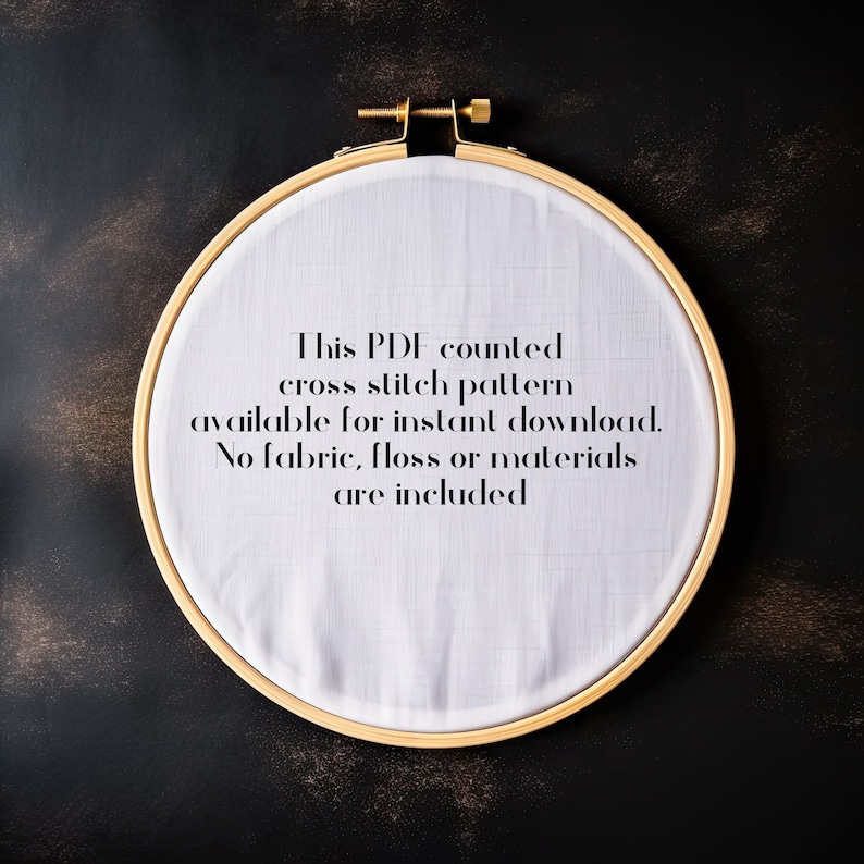 May include: A wooden embroidery hoop with white fabric stretched inside. The text on the fabric reads: "This PDF counted cross stitch pattern available for instant download. No fabric, floss or materials are included."