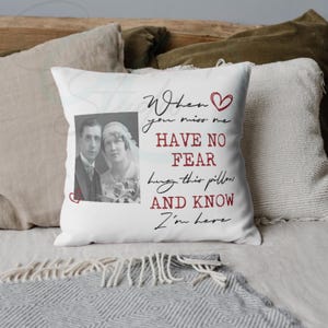 May include: White cushion featuring a black and red text overlay and a black and white photograph of a couple. The text says "When you miss me, have no fear, hug this pillow and know I'm here."