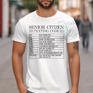 May include: White t-shirt with black text that reads "Senior Citizen Texting Code" and a list of abbreviations and their meanings. The abbreviations are common slang used by older people.