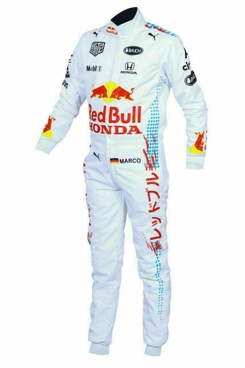 May include: White racing suit with Red Bull and Honda logos. Features sponsor logos, red and blue accents, and Japanese text. Includes the name "MARCO" and a German flag patch.