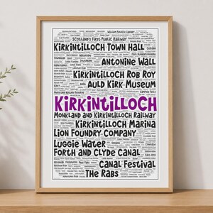 May include: A framed word cloud art print featuring the text Kirkintilloch in large purple letters, surrounded by smaller black text listing local landmarks and historical sites such as Antonine Wall, Rob Roy, and the Forth and Clyde Canal.
