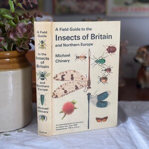 May include: A hardcover book titled A Field Guide to the Insects of Britain and Northern Europe by Michael Chinery. The cream-coloured cover features detailed colour illustrations of various insects, including a large lacewing and a dragonfly.