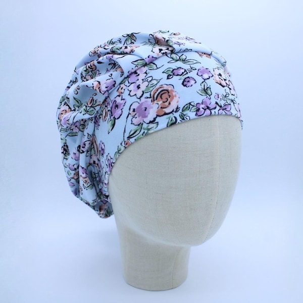 Antique Etched Flowers on Blue Double Brushed Poly in a Bouffant Style Scrub Cap