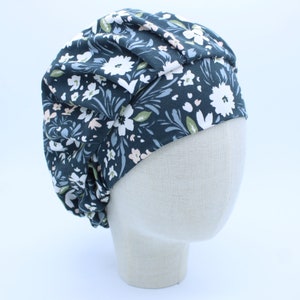 White and Soft Blue Dainty Flowers on Dark Background in a Bouffant-Style Scrub Cap