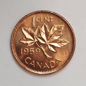 May include: A copper-colored Canadian 1 cent coin with a maple leaf design and the year 1959. The coin also has the text "1 CENT" and "CANADA" around the edge.