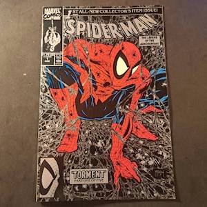 May include: A comic book cover featuring Spider-Man in a red and blue suit, swinging through a web of black and silver. The cover text reads "Spider-Man" and "The Legend of the Arachknight".