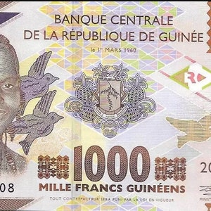 May include: A 1000 Guinean Franc banknote featuring a portrait of a young woman smiling, three birds in flight, and the coat of arms of Guinea. The banknote is dated 1 March 1960 and has the text "Banque Centrale de la République de Guinée" printed on it.