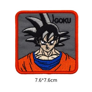 May include: A gray and orange embroidered iron-on patch featuring a cartoon image of Goku from Dragon Ball Z. The patch is 7.6 inches by 7.6 inches and has the word "Goku" embroidered in white on the top right corner.