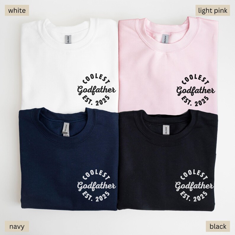 May include: Four sweatshirts in different colors: white, light pink, navy, and black. Each sweatshirt has the text "COOLEST Godfather EST. 2025" printed on the front.