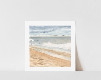 May include: Watercolor painting of a beach scene. The artwork depicts a sandy beach with gentle waves rolling towards the shore under a cloudy sky. The colors are muted, with shades of blue, beige, and gray.