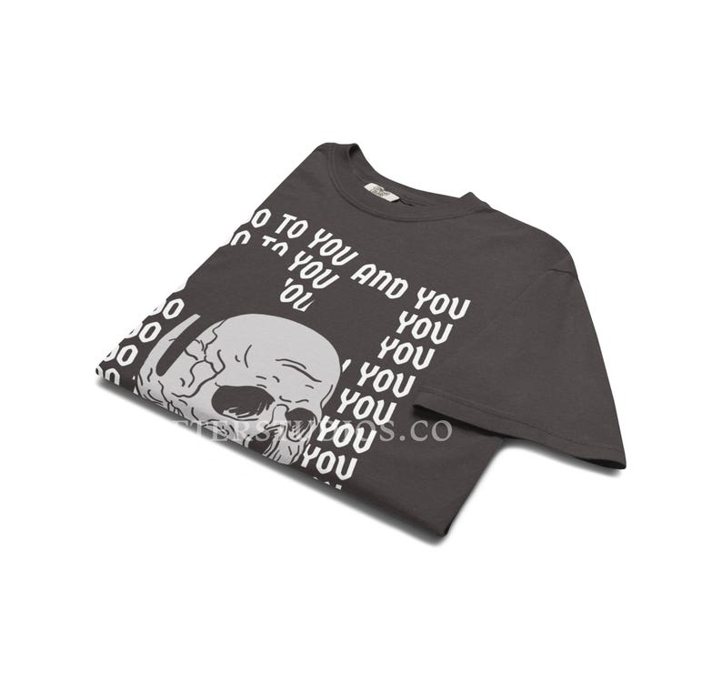 Może przedstawiać: Ciemnoszary t-shirt z kr&oacute;tkim rękawem z białą grafiką ludzkiej czaszki w lewej dolnej części. Tekst "TO YOU AND YOU" jest nadrukowany na biało w powtarzającym się wzorze wok&oacute;ł czaszki, przy czym słowo "YOU" jest powt&oacute;rzone wielokrotnie.