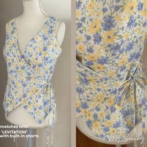 May include: A sleeveless wrap top with a floral pattern of yellow and blue flowers on a cream background. The top has a V-neck and ties at the side. The text on the image says "matches with 'LEVITATION' skirt with built-in shorts."