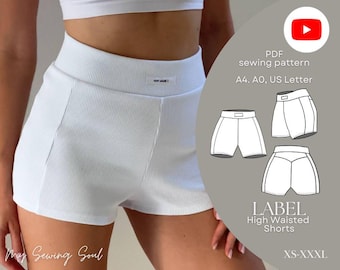 May include: White high-waisted shorts in a ribbed fabric. The image shows the shorts with a white crop top. A PDF sewing pattern is included, with the text "LABEL High Waisted Shorts" and sizes "XS-XXXL".