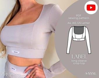 May include: A pale grey long-sleeved crop top with a square neckline and ribbed texture. The top features a small label reading "I Made This". The image also shows a PDF sewing pattern for the top, labelled "LABEL long sleeve crop top", with sizes S-XXXL.