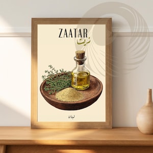 May include: A framed print with a white background featuring a wooden bowl with a green herb, a small bottle of oil, and a pile of beige spice. The text "ZAATAR" is written in black at the top of the print, with the Arabic word for "zaatar" written in brown below it. The word "ZAYT" is written in brown at the bottom of the print.