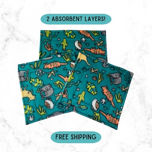 May include: Three teal absorbent pads with a colorful jungle animal print. The pads feature a pattern of koalas, snakes, and other animals, along with cacti and leaves. The text "2 ABSORBENT LAYERS!" is visible.