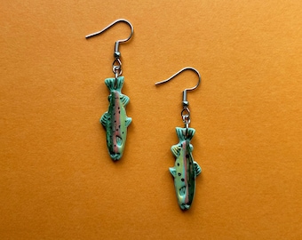 May include: A pair of silver earrings with a green, yellow, and red trout design.
