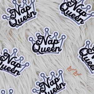May include: Multiple white iron-on patches with a black embroidered crown and the text "Nap Queen".