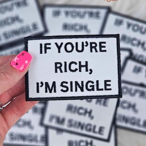 May include: A white iron-on patch with black text that reads "If you're rich, I'm single".