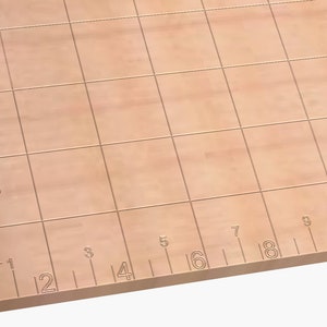 May include: A brown cutting mat with a grid pattern and inch measurements along the edges. The mat is made of a durable material and is ideal for crafts, quilting, and other projects.