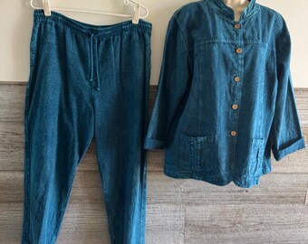 May include: A two-piece teal-colored outfit, consisting of pants and a button-up jacket. The pants have a drawstring waist. The jacket features a mandarin collar and two front pockets. The outfit is displayed on a hanger and a mannequin.