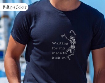 May include: A navy blue t-shirt with a white skeleton dancing and the text "Waiting for my meds to kick in".
